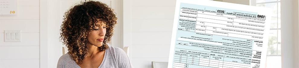 Woman doing taxes with computer, IRS form 1040, and USPS Priority Mail envelope.